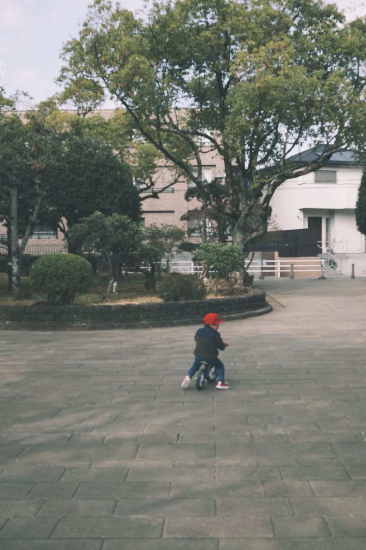 A child crossing an empty plaza.