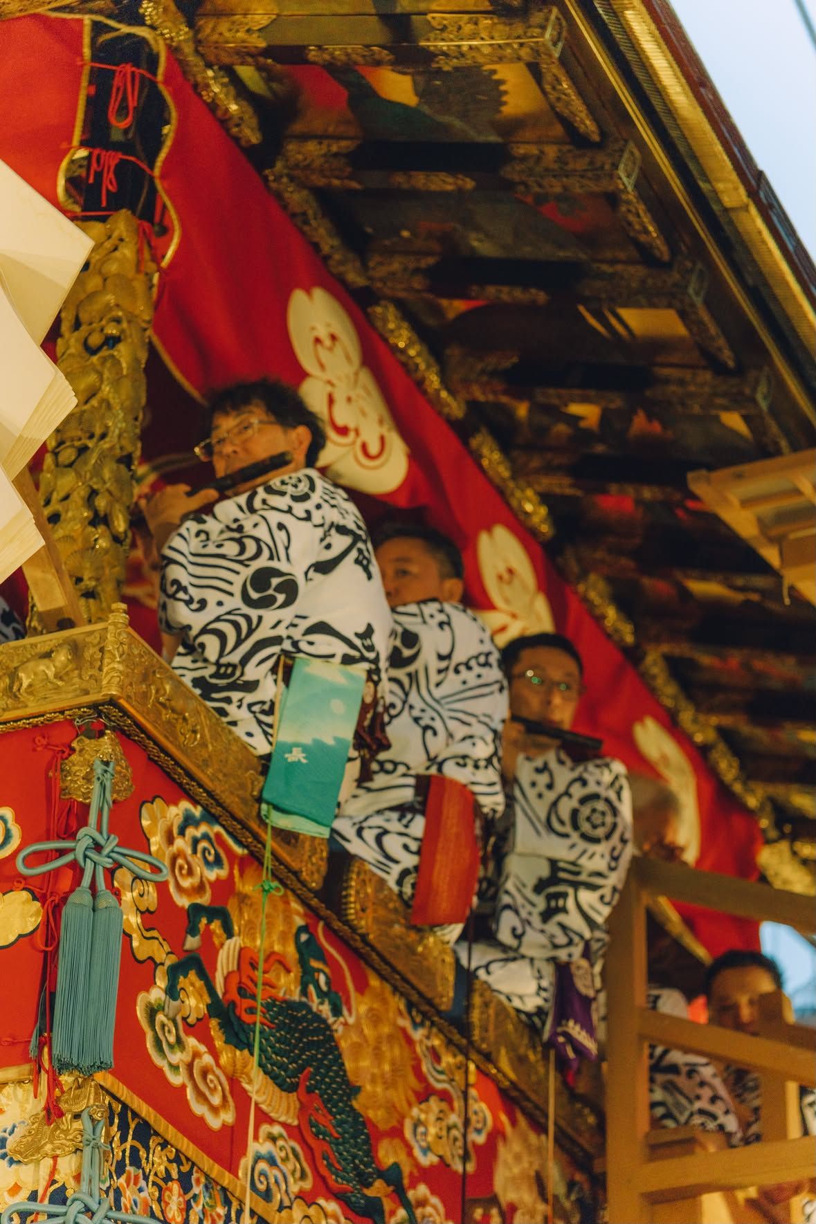 Musicians on a festival float, at dusk.